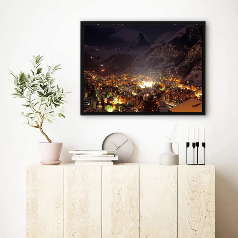 Постер «Ночной город около гор» на стене в офисе