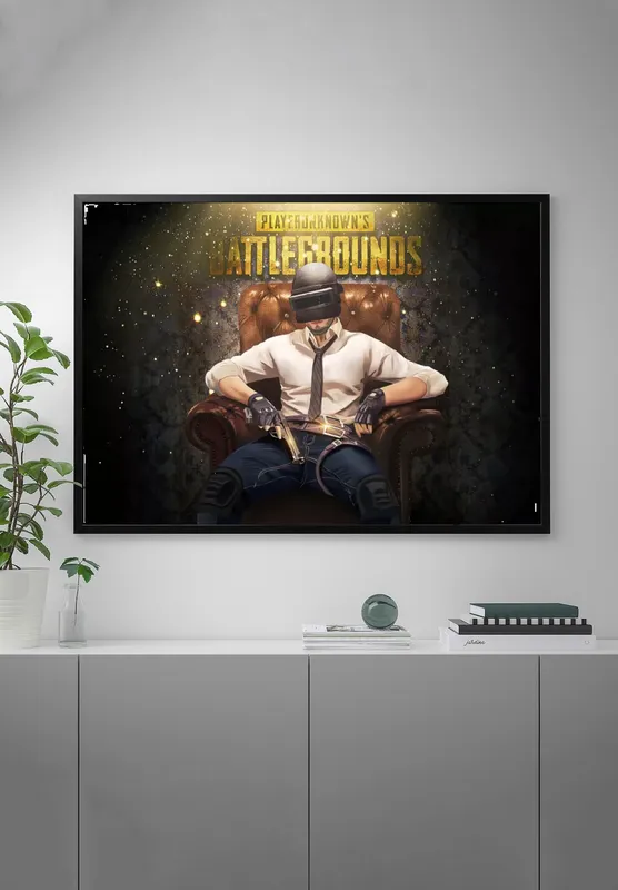 Постер «PUBG. В кресле с пистолетом» на стене в офисе